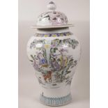 A large Chinese baluster vase and cover decorated with figures in a landscape, 6 character mark to