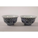 A pair of Chinese blue and white porcelain tea bowls with scrolling lotus flower decoration, 4