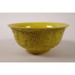 A Chinese yellow ground porcelain bowl with all over raised dragon decoration, impressed seal mark