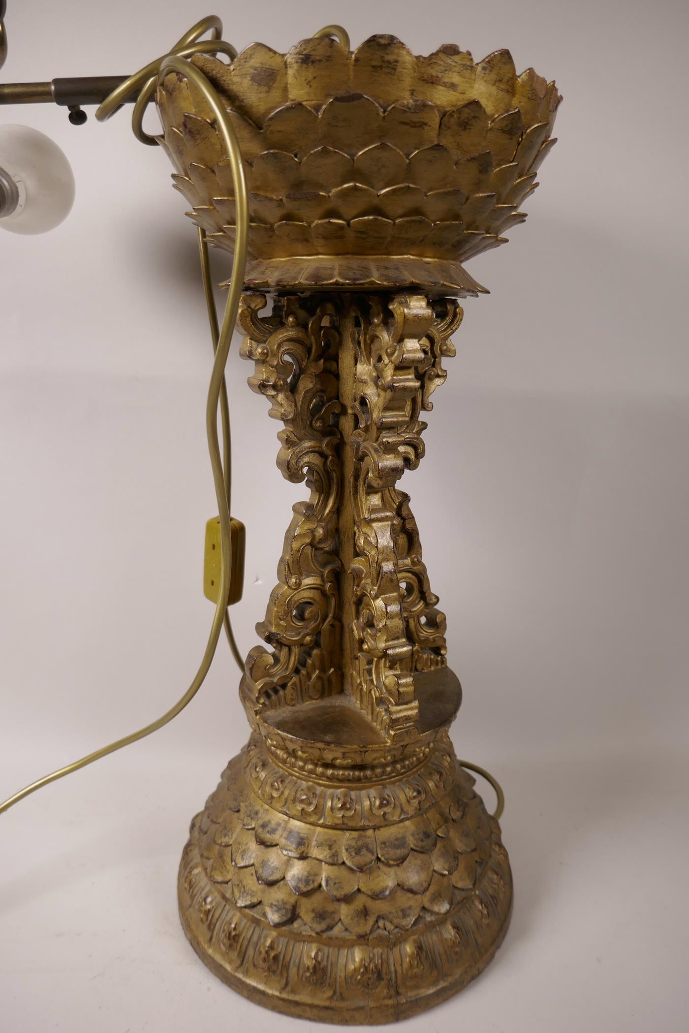 A carved, gilt wood table lamp base, the base and crown in the form of lotus flowers, 19" high