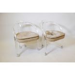 A pair of mid C20th Charles Hollis Jones design lucite elbow chairs on castors, with faux suede seat