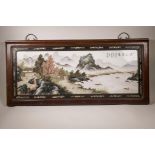 A Chinese polychrome enamelled porcelain panel with landscape decoration of a riverside village,