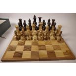 A large turned wood chess set with folding board, kings 5" high