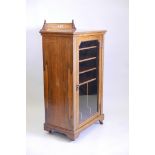 A Victorian inlaid rosewood music cabinet with single glazed door and interior fitted with