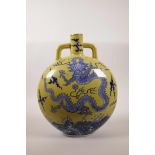 A Chinese yellow ground two handled porcelain moon flask with blue and white decoration of a