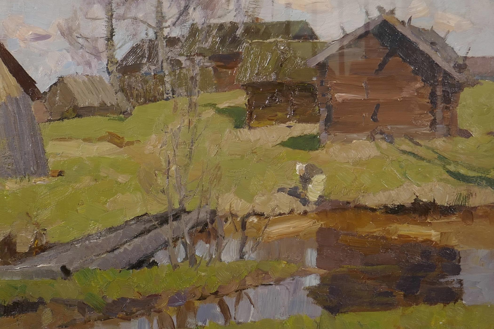 A Russian School oil painting, dwellings in a landscape with figures by a lake to foreground, signed