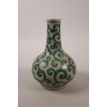 A Chinese pottery bottle vase with scrolling green enamel decoration, 6 character mark to base,