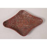 An antique Chinese red lacquer shaped dish with floral decoration, 8½" x 6"