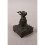 A Chinese bronze square form seal with knop in the form of a ram's head and green patina, 3½" high