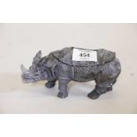 A cold painted bronze inkwell in the form of a rhinoceros, fitted with two wells, lacking liners,