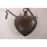 A Moorish bronze powder flask engraved with hunting scenes, 4" wide