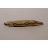 A carved horn figure of an alligator, 4" long
