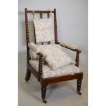 A William IV bobbin turned open elbow chair, with faux rosewood grained decoration