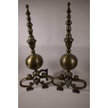 A pair of heavy brass fire dogs of turned and ball form on lion's mask scroll feet, 26" high