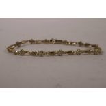 A 10ct yellow gold (untested) diamond set bracelet, 7" long