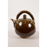 A Chinese brown glazed pottery teapot, with dragon handle, 5" high