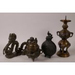 An Oriental bronze figurine of a dragon, 6½" long, together with an incensor, pricket candlestick