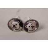 A pair of white metal cufflinks set with cold enamel plaques depicting French bulldogs
