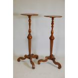 A pair of C19th walnut torcheres with marquetry inlaid decoration, raised on tripod supports, 44½"