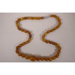 A Baltic amber graduated bead necklace, 17" long