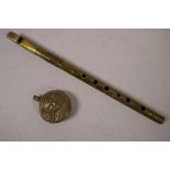An early brass penny whistle and a brass Trench Art miniature flask