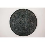 An Oriental green hardstone hand mirror with carved phoenix decoration to one side, 6" diameter