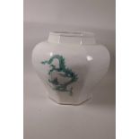 A large Chinese bulbous pot of octagonal form painted with five toed dragons on a celadon ground,