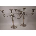 A pair of C19th Sheffield plated candlesticks with reeded columns and oval bases, 12" high, with two