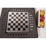 A small metal chess set, board 7½" square, in a fitted box, together with a set of three Atlas