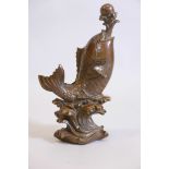 A Chinese bronze model of a leaping fish with pearl, 16" high