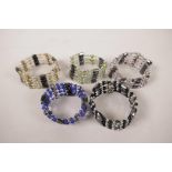 A collection of five magnetised beaded bracelets with cloisonné feature beads