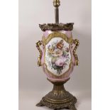 A Continental porcelain and bronze mounted table lamp base, hand painted with flowers and a courting