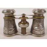 A pair of silver plated opera glasses having embossed decoration of hunting scenes, cased