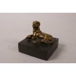 A Chinese square form bronze seal with a gilt knop in the form of a temple dog, 3" x 3"