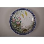 A Chinese polychrome porcelain plate with enamel decoration of waterfowl and flowers, seal mark to