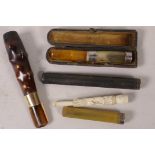 A hallmarked silver and amber cigarette holder together with four other holders