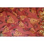 A pair of floral embroidered red ground curtains, 88" drop, 100" wide