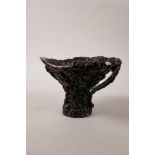 A Chinese faux horn libation cup with moulded decoration of figures and gourds, 4" high