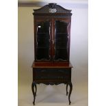 A mahogany Chippendale style bookcase, with glazed upper section over a base of two drawers, all