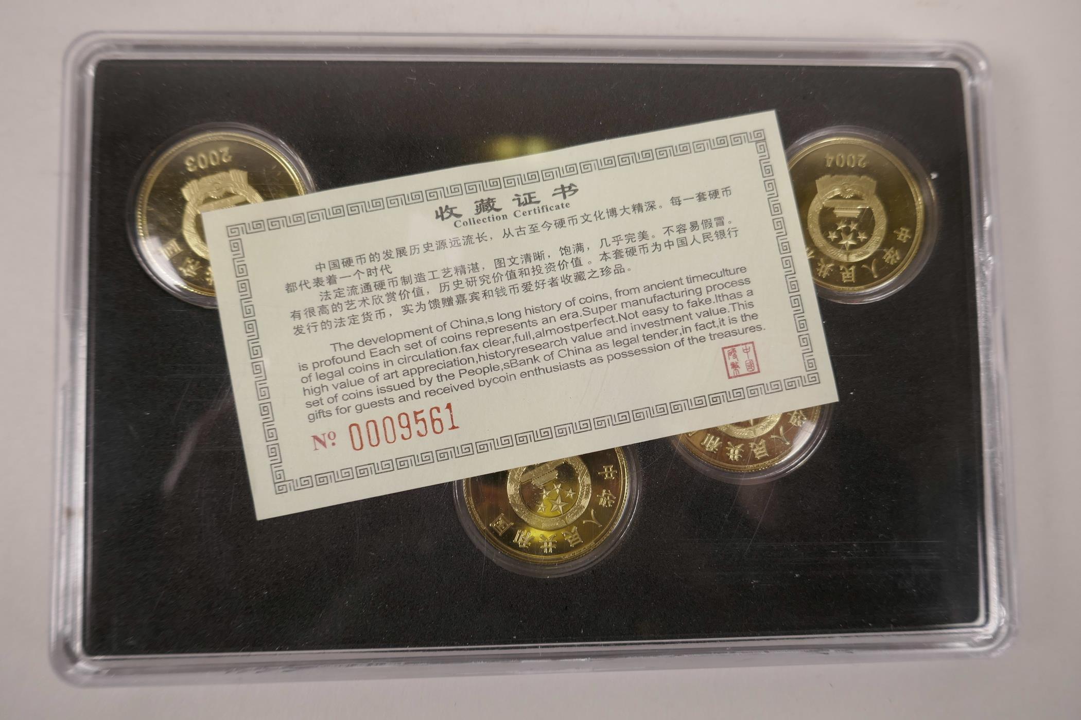 A cased collection of facsimile (replica) Chinese gilt metal coins commemorating important monuments - Image 3 of 3