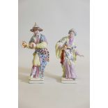 A pair of porcelain figures of dancers in Oriental costumes, 15" high