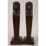 A pair of carved wood column bookends carved with Egyptianesque heads, 10" high