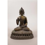 A Sino-Tibetan bronze Buddha with gilt patina, double vajra mark to base, 6½" high