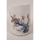 A Chinese porcelain brush pot decorated with a flowering branch and calligraphy, blue seal mark to