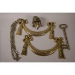 A pair of gilt metal ribbon pattern embellishments, 12" x 6" together with a cast metal dog's