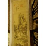 A Chinese scroll depicting figures in a mountain landscape, signed with calligraphy and red seal