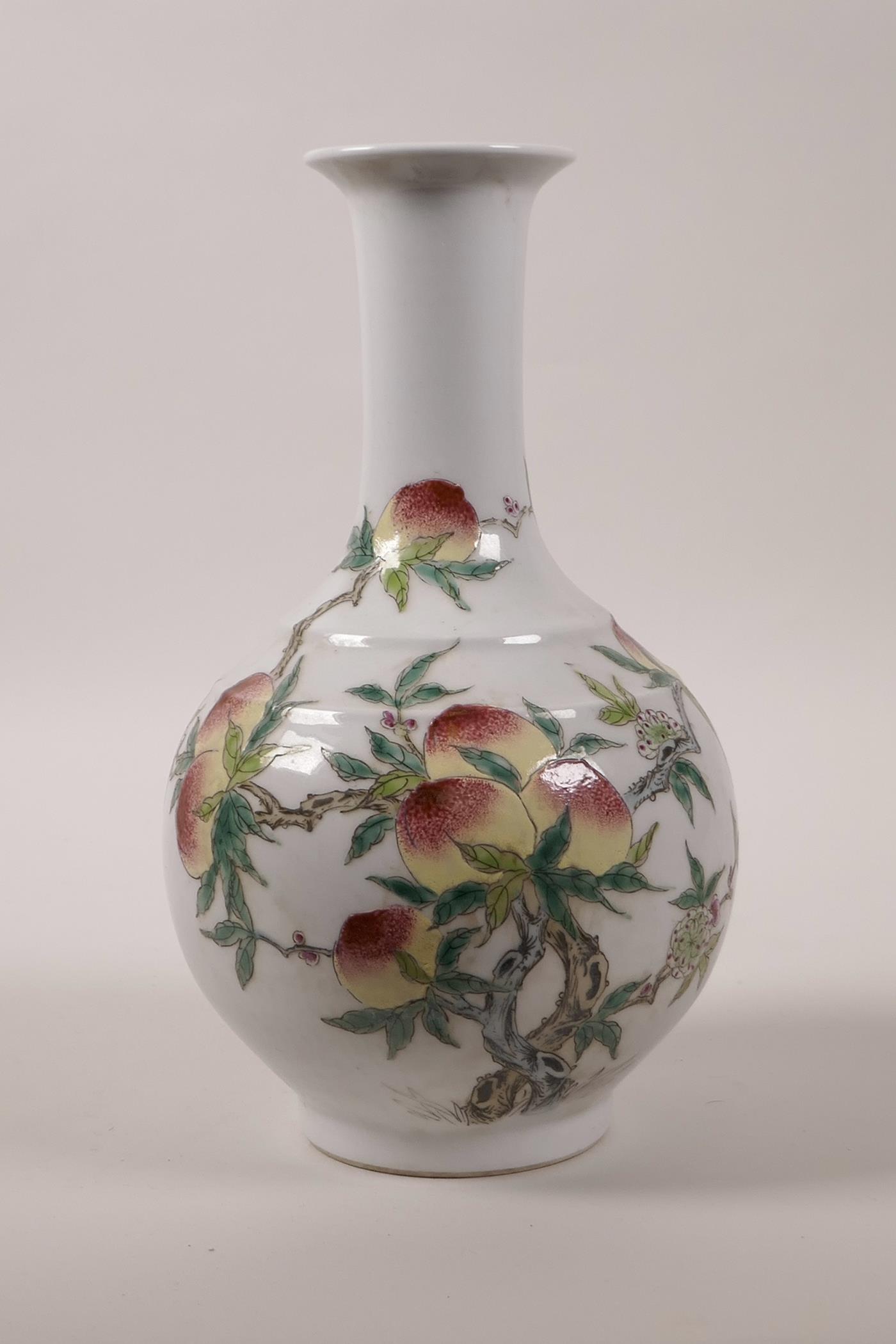 A Chinese polychrome porcelain vase with enamelled peach tree decoration, seal mark to base, 10"