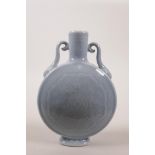 A Chinese powder blue glazed two handled moon flask with underglaze lotus flower decoration, seal