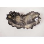A Chinese faux horn dish in the form of a lotus leaf, 5" wide