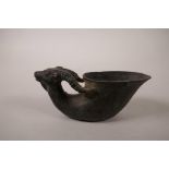 A Chinese bronze libation cup with a handle in the form of an antelope, impressed mark to base,